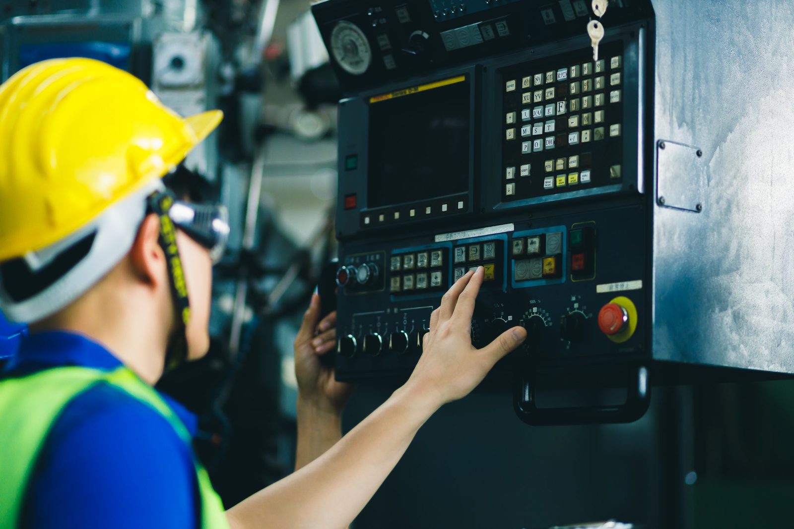 Machine operator at a CNC control panel